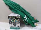a green umbrella sitting on a table next to a box