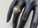 an image of a woman ' s hand with a ring on it