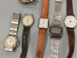 a lot of watches that are sitting on a table