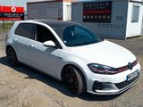 the volkswagen golf gtr is parked in front of a building