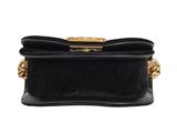 a black leather bag with gold hardware