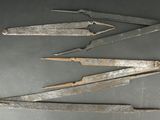 four old metal tools sitting on top of a table