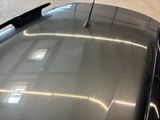 a flag on the roof of a car in a parking lot