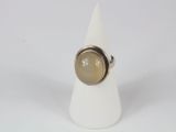 a close up of a white cone with a ring on it
