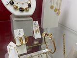 a display of jewelry on display in a glass case