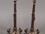 pair of antique brass candlesticks with ornate designs on each end