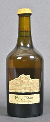 bottle of wine with a label on it sitting on a table
