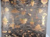 a black cloth with gold and red designs on it