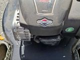 a lawn mower that is sitting on the ground