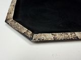 a picture of a black and white plate on a white table
