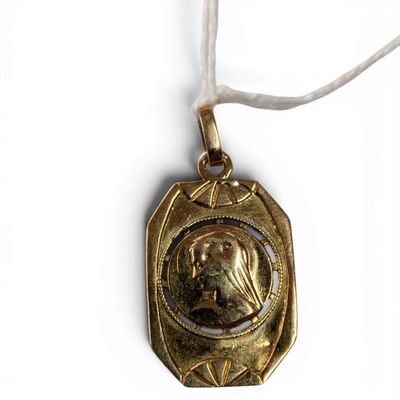 an image of a gold necklace with a picture of a woman on it