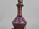 an image of a red and blue vase with a light on it