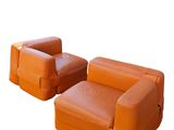 pair of orange leather sofas on white background