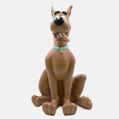 the figurine of scooby is sitting on a white surface