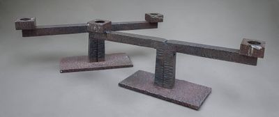 two pieces of metal that are on a white surface