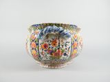 an image of a vase with flowers and leaves painted on it