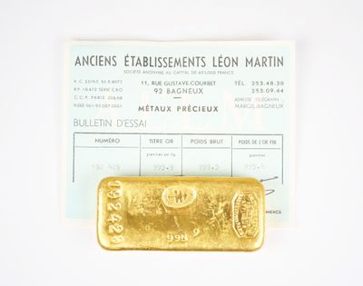 a gold bar sitting on top of a piece of paper