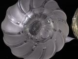 a close up of a glass object on a black surface