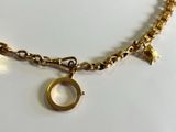necklace with a gold ring and a star charm on a gold chain