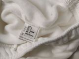 a close up of a white shirt with a label on it