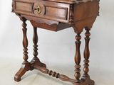 an old wooden table with a drawer on top of it