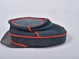 a close up of a hat with a red stripe on it