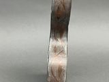 a close up of a metal object on a gray surface