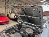 a car that is under the hood in a garage