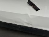a close up of a white car with a remote control on it