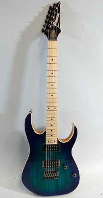 an electric guitar sitting on top of a white surface