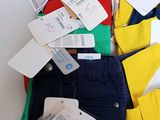 a pile of clothes with tags on them on a table
