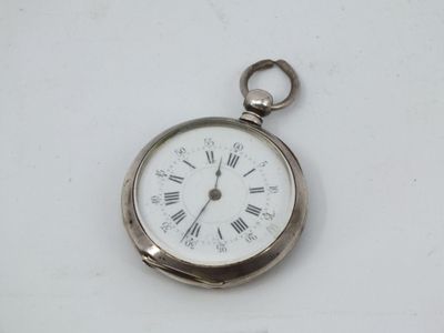a silver pocket watch with roman numerals on it