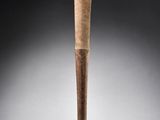 an old baseball bat with a wooden handle on a gray background