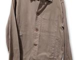 an image of a jacket hanging on a hanger on a white wall