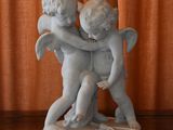 a statue of two cherenshes hugging on a table
