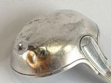 a silver spoon with a bird shaped handle on it