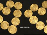 gold coins are arranged in the shape of a heart on a black background