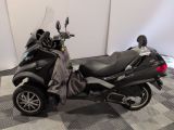 a motorcycle that is parked on a checkered floor