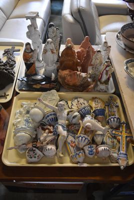 a table with a tray of pottery and a tray of figurines on it