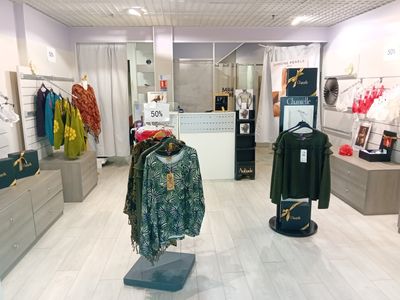 an image of a clothing store with clothes on display