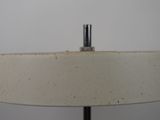 a close up of a table lamp with a white shade