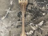 a fork that is sitting on a marble table