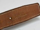 an image of a brown leather belt with white stitching on it