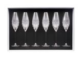 four empty wine glasses in a black box on a white background