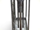 a metal cage that has a metal handle on top of it