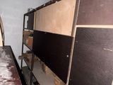 a room with a desk and a shelf with boxes on it