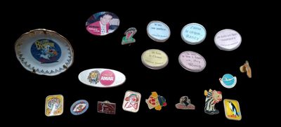 a lot of pins and magnets on a black surface
