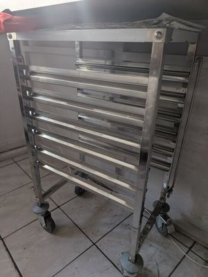 a metal rack that is sitting on a tile floor