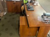 a desk with a chair and a computer on it