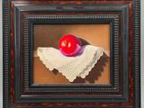 a painting of a red apple on a white napkin